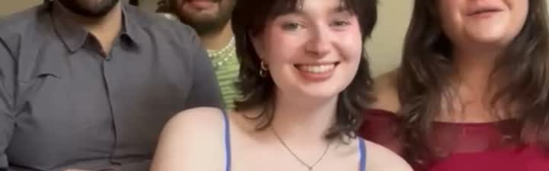 Main image: Ali, Mhairi, Gonçalo and Fran, LGBTQ+ singers from London Contemporary Voices sat smiling at the camera before their a Capella performance of Life On Mars? by David Bowie.