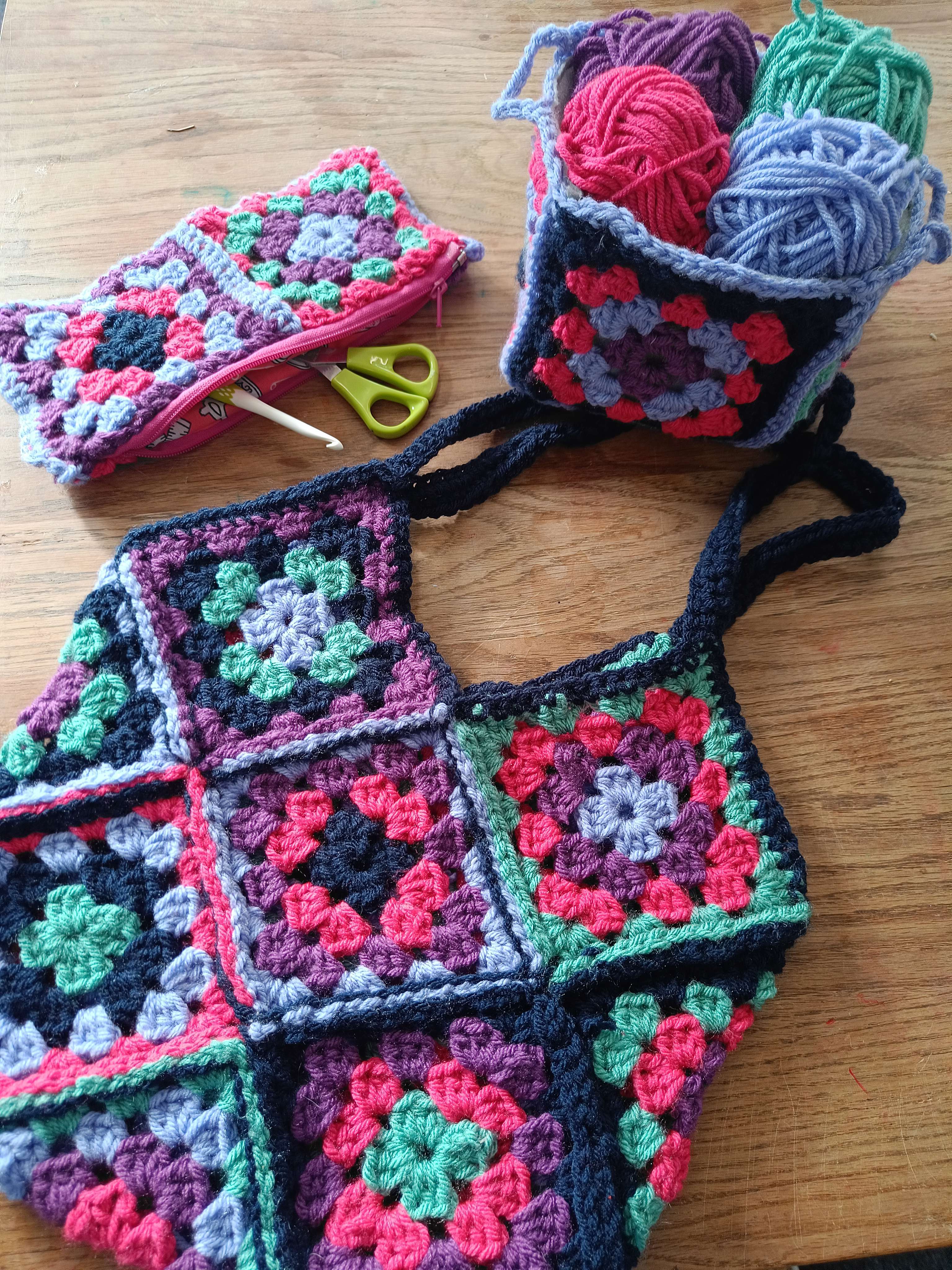 a crochet bag made from handmade crochet granny squares