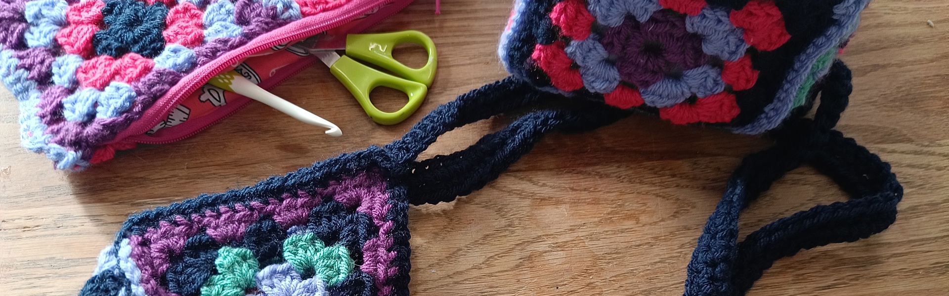 a crochet bag made from handmade crochet granny squares