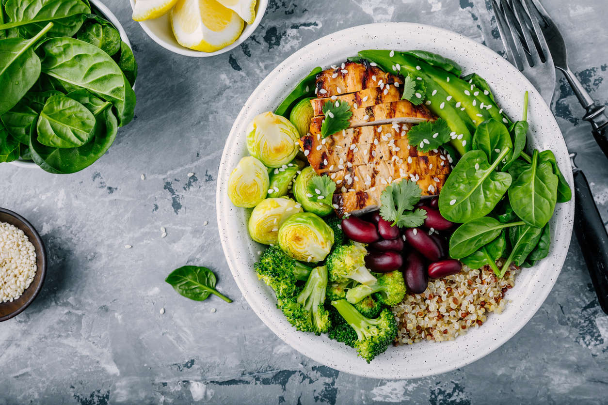 a chicken salad with kidney beans, Brussel sprouts, quinoa, spinach and sesame seeds