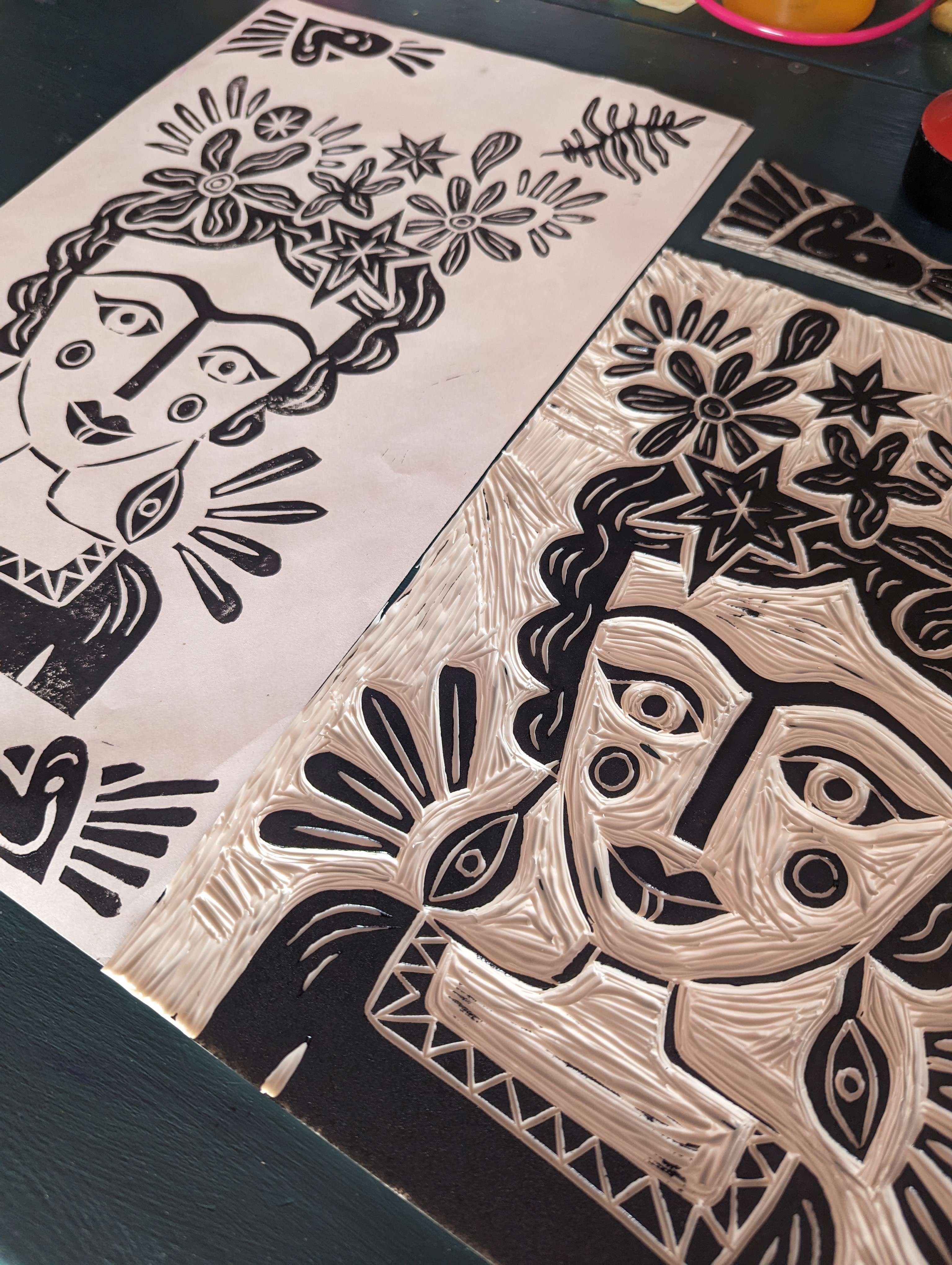 silver coloured lino printed pattern on black background depicting image of Frida Kahlo