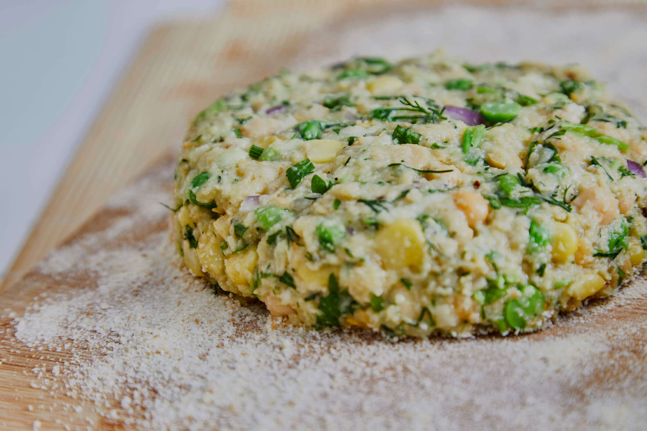 a close up of a vegetable cutlet on a wooden board