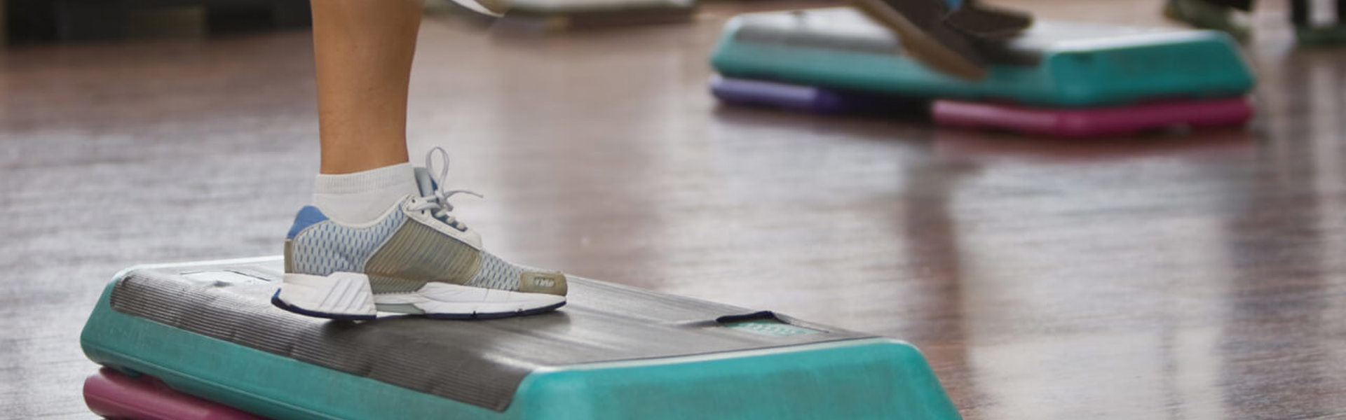 A close up of a pair of trainers and step aerobics equipment