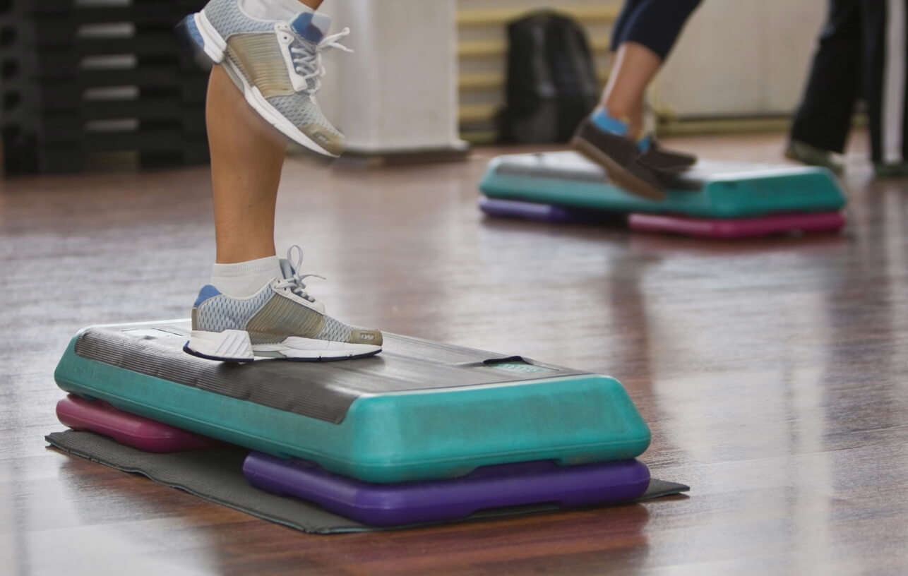 A close up of a pair of trainers and step aerobics equipment