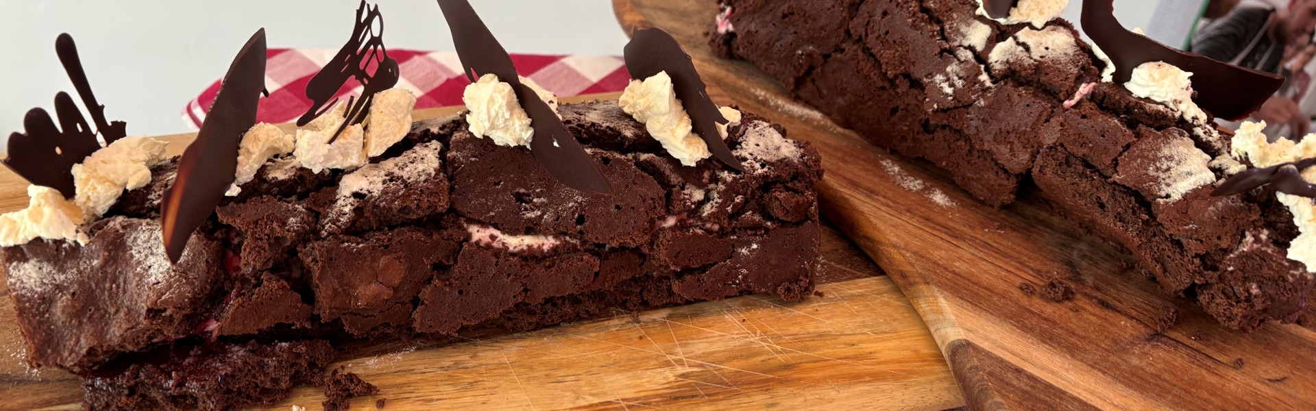 Main image: a Christmas chocolate yule log, roulade recipe, decorated with cream and chocolate shards on top. 
