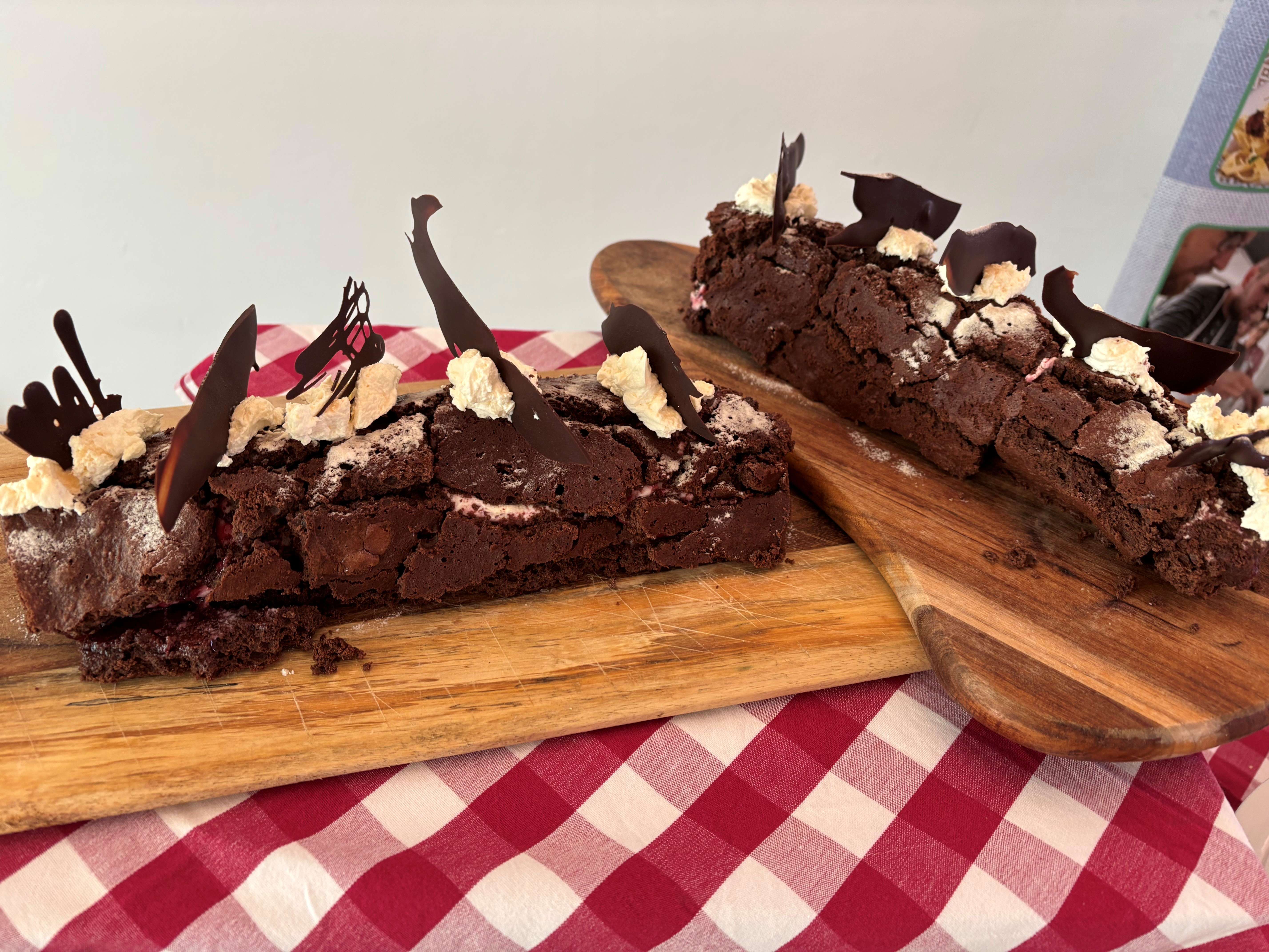 Main image: a Christmas chocolate yule log, roulade recipe, decorated with cream and chocolate shards on top. 