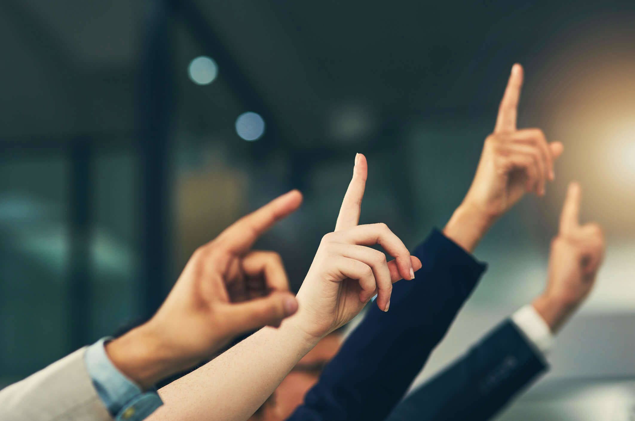 Hands in the air ready to ask a question 