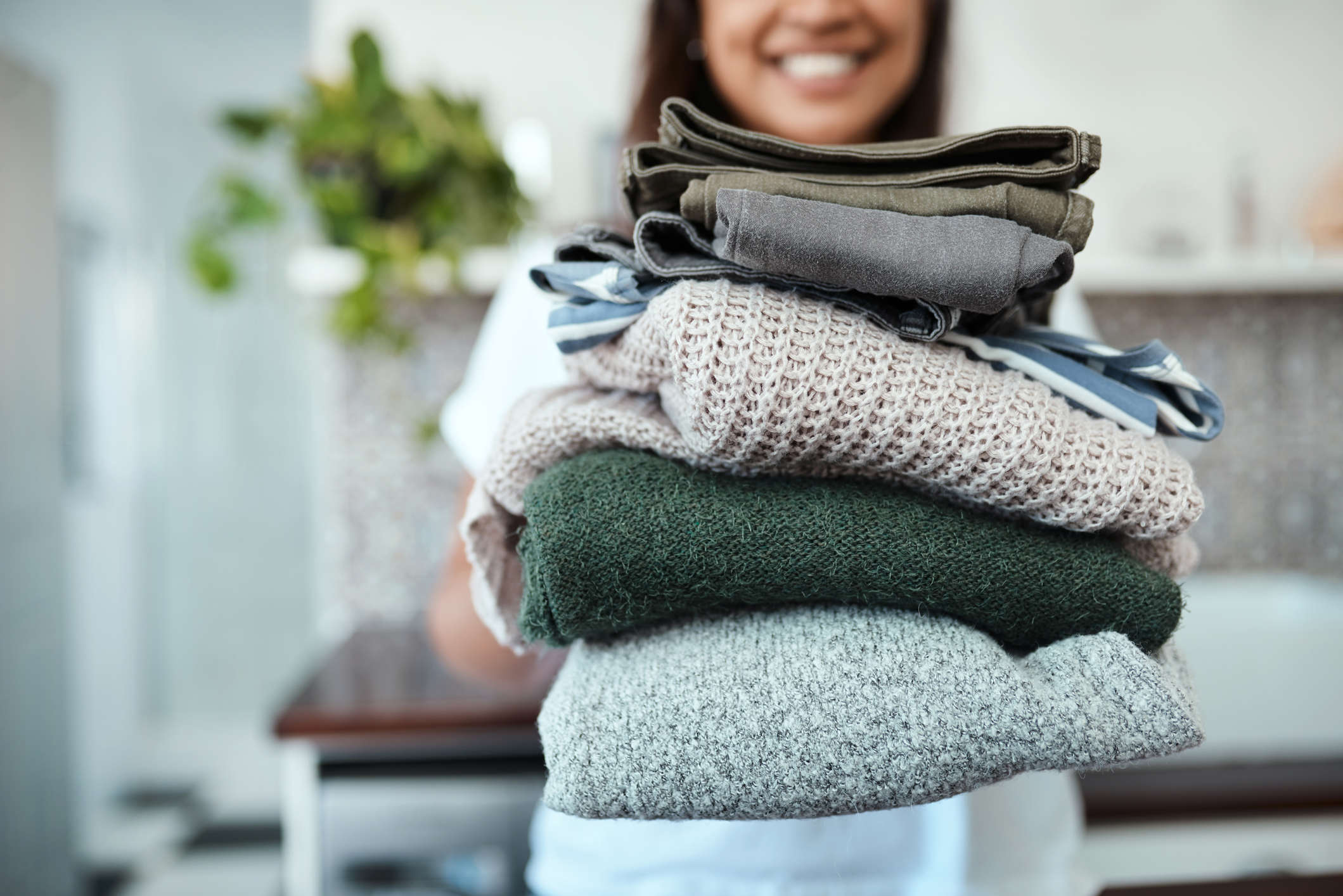 Main image: a stack of folded clothes, a great habit you already to to add a new habit to with habit stacking.