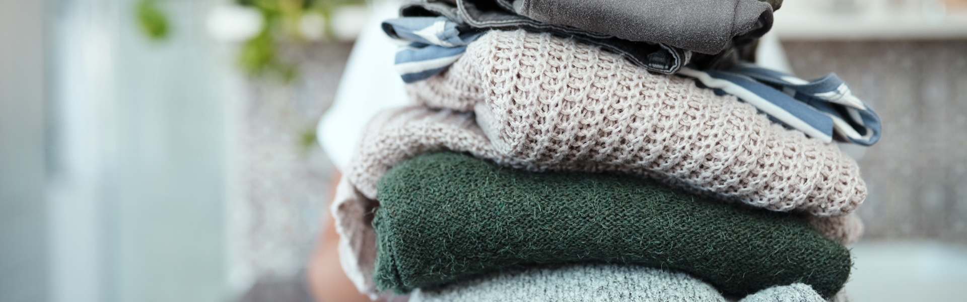 Main image: a stack of folded clothes, a great habit you already to to add a new habit to with habit stacking.