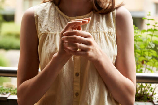 A person practising EFT, tapping on the karate chop point.