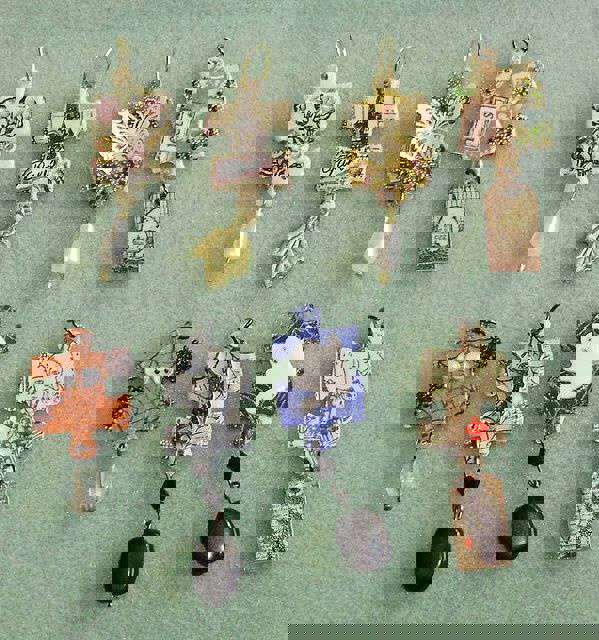 Main image: DIY Jigsaw Piece Pendants decorated in different designs, with beads dangling from them.