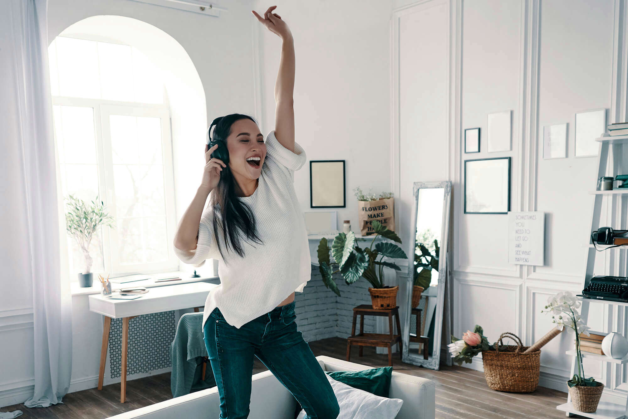 A young woman dancing in her front room