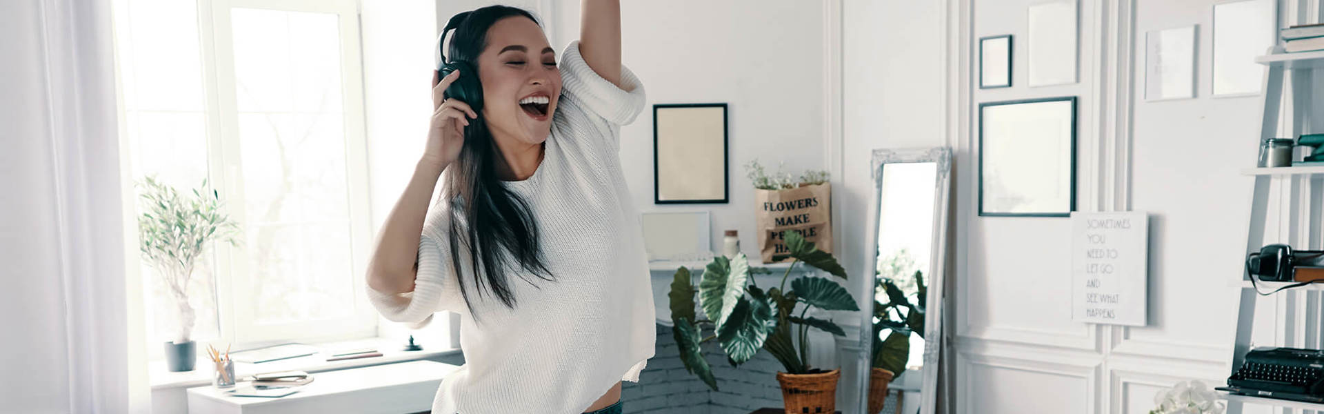 A young woman dancing in her front room