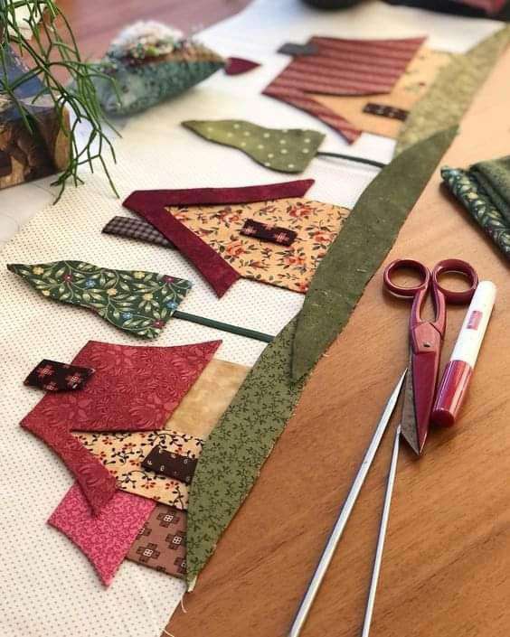 A close up of an applique village scene made by Kate Nisbet