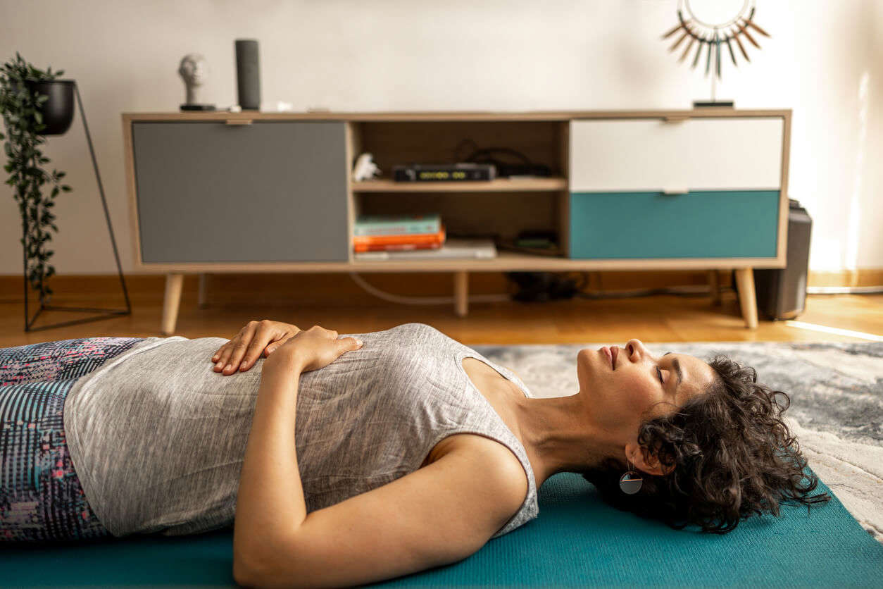 a woman laying on the living room floor relaxing