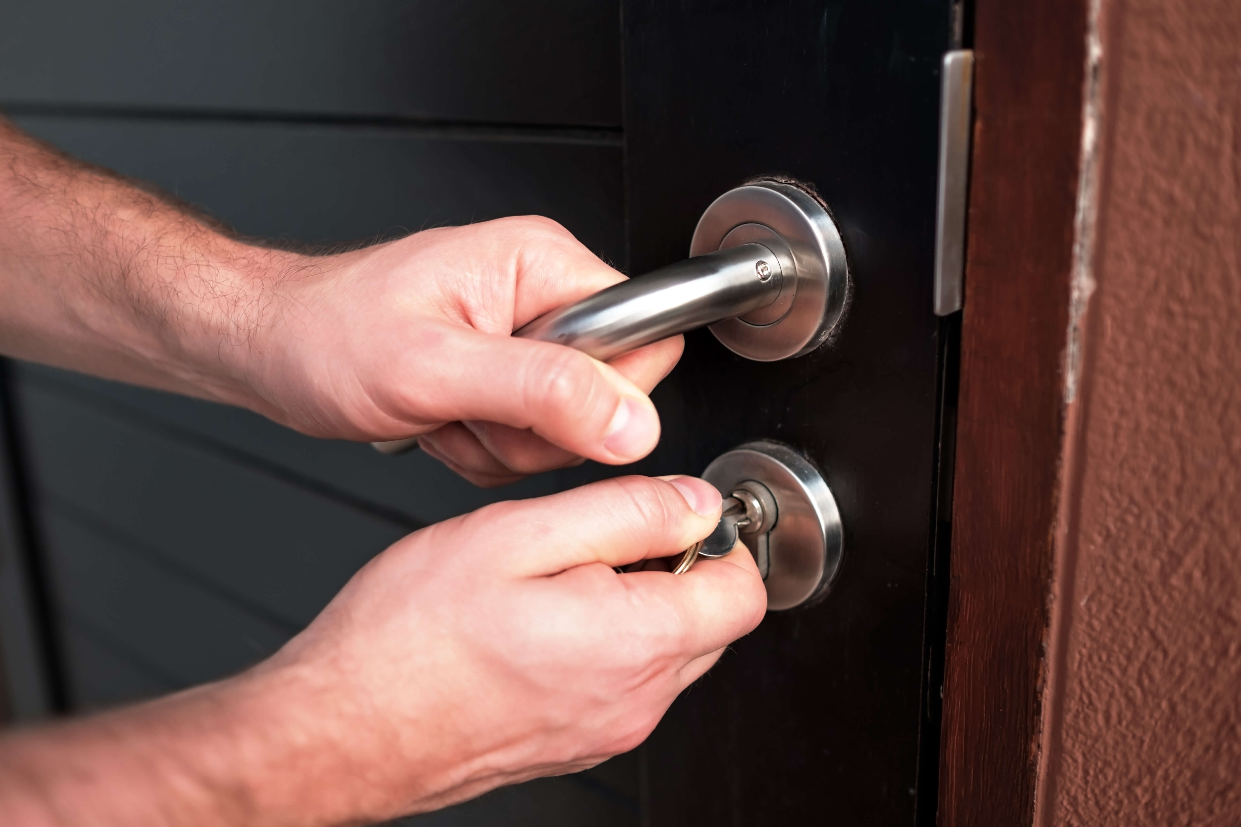 a close up of someone checking a door handle and lock