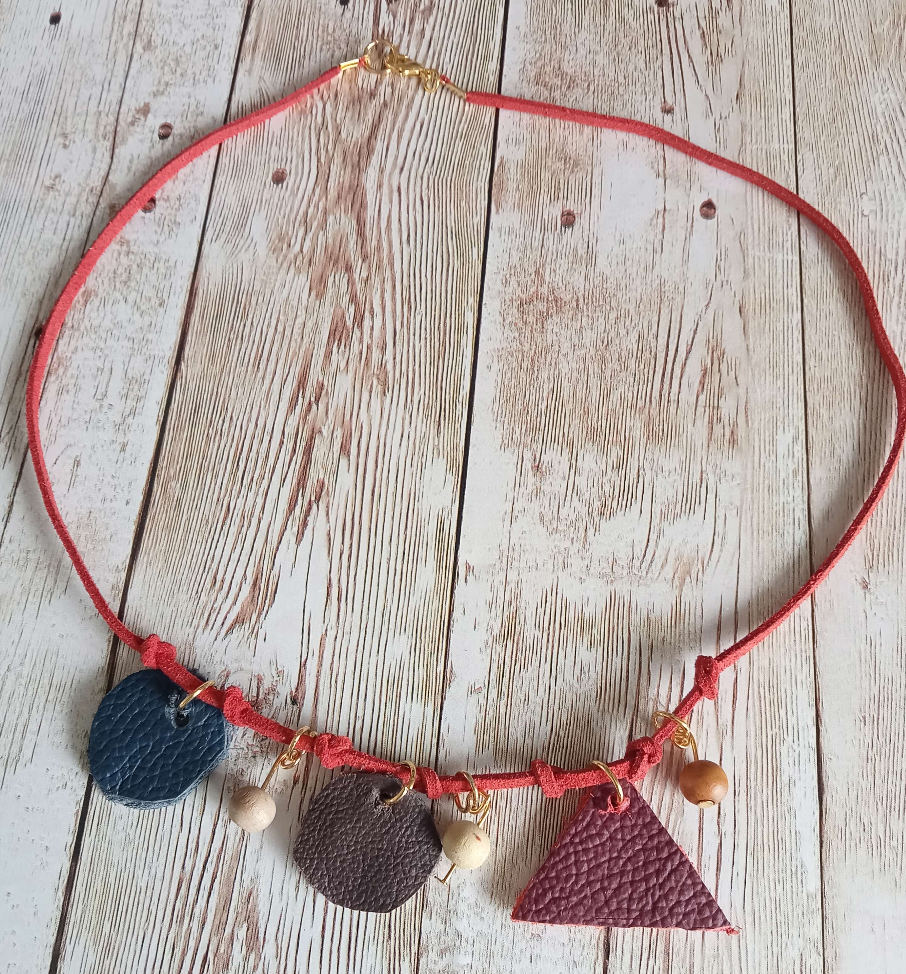 Main Image: a close up of a leather and bead necklace made by Kate Nisbet