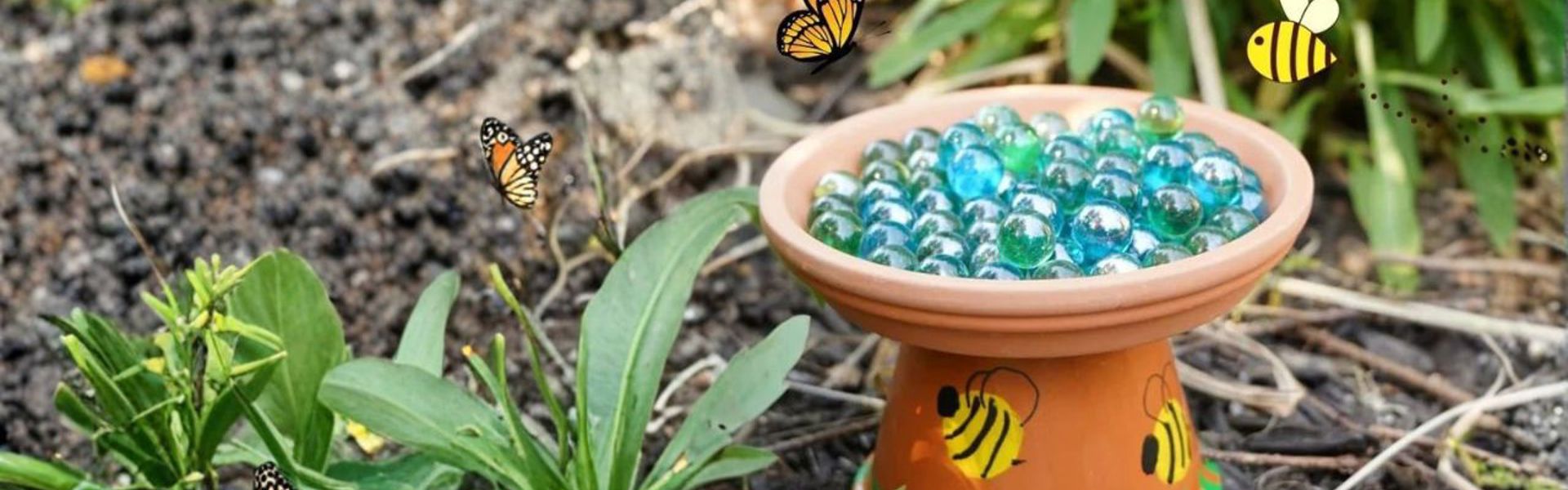 Main image: a DIY bee bath for the garden, made from a terracotta pot and saucer with marbles for the bees to land on. With cute yellow bees painted on the side.