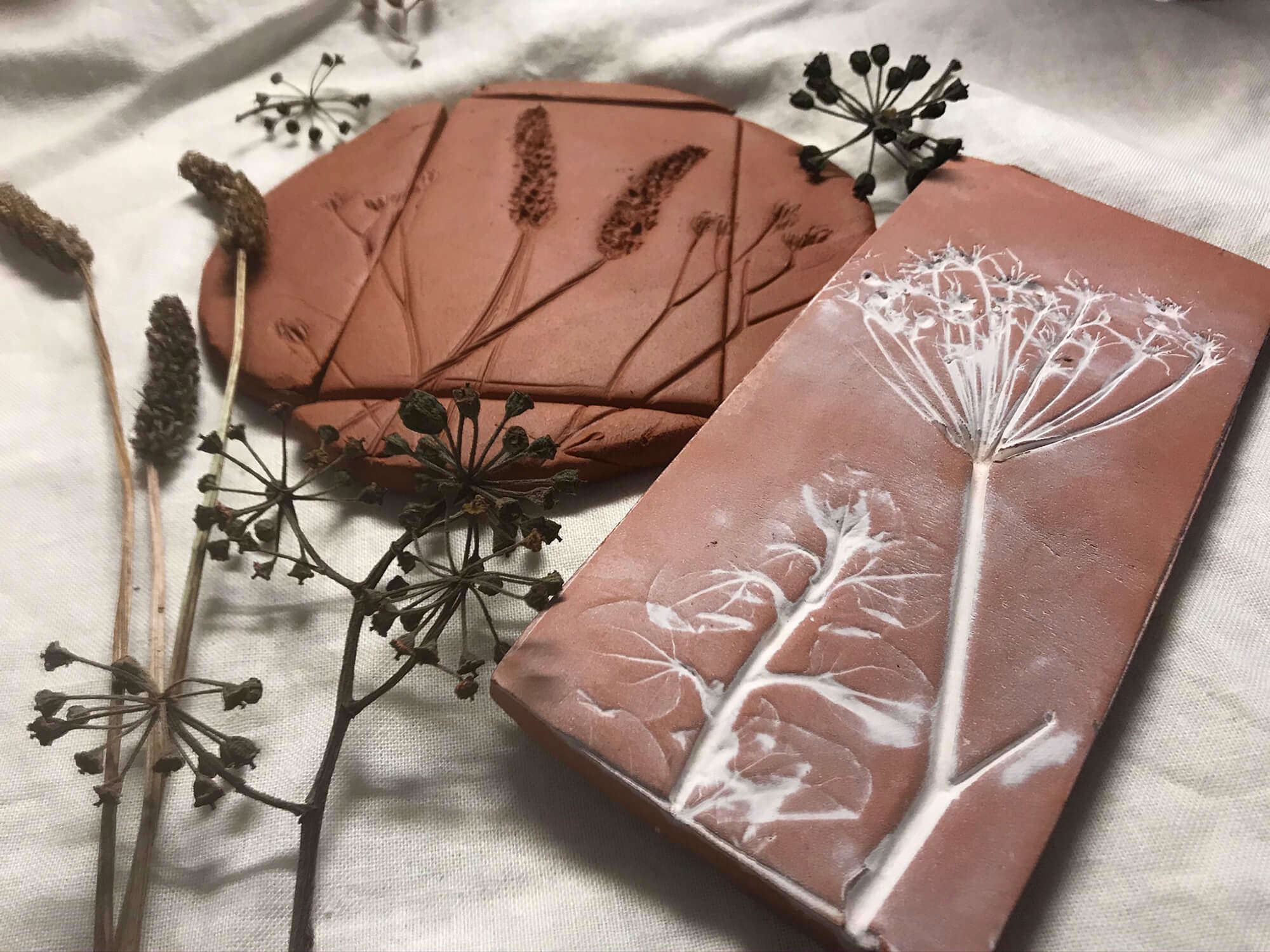 A close up of botanical clay leaf tiles created by Rachel Moore