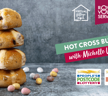 a stack of hot cross buns surrounded by chocolate mini Easter eggs