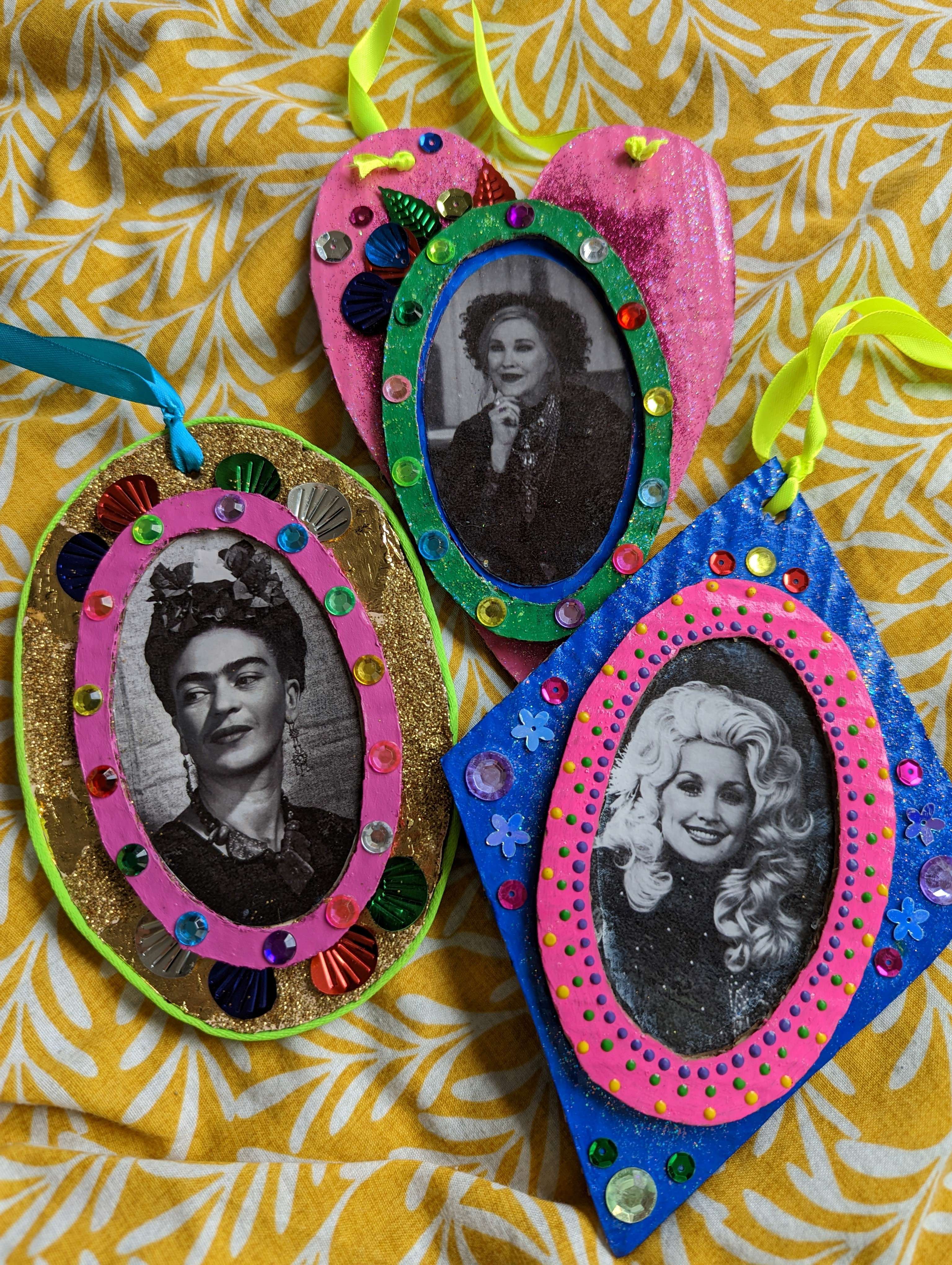 colourful embellished collage carboard decorations featuring pictures of Frida Kahlo, Dolly Parton and Catherine O'Hara