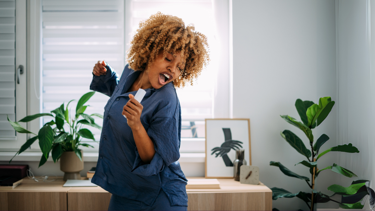 Main image: a woman dancing in her living room, taking part in the dance your way through menopause class with jo!