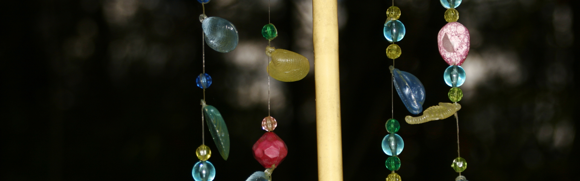 a close up of a multicoloured beaded windchime