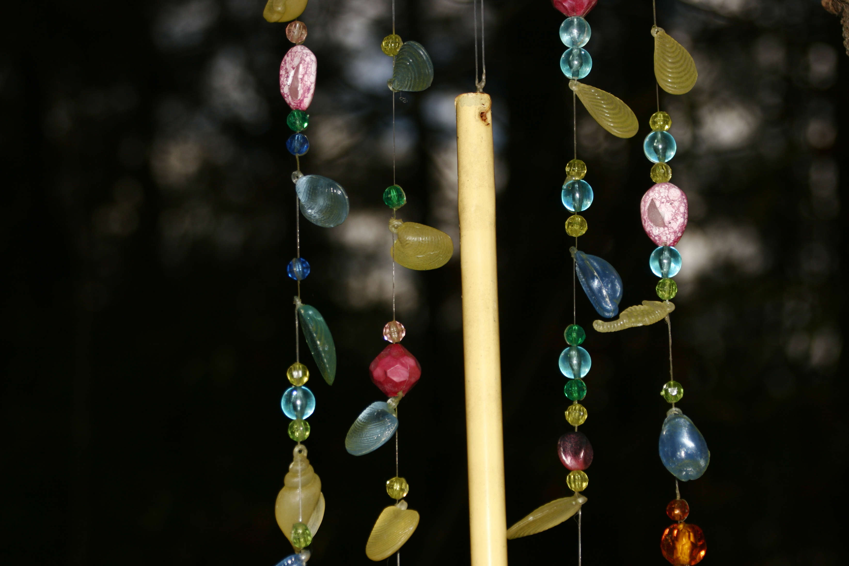 a close up of a multicoloured beaded windchime