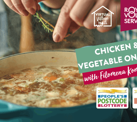 a close up of a cooking chicken and vegetable one pot in a blue cooking pot with someone pinching fresh rosemary into it