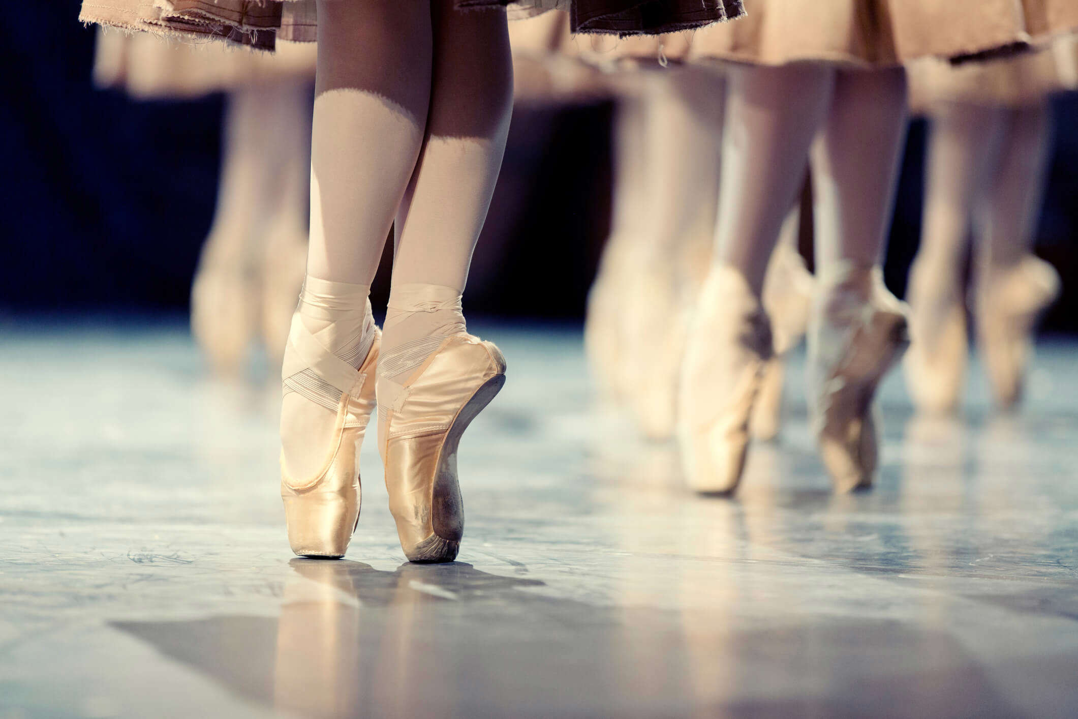 a close up of ballet performer wearing ballet shoes