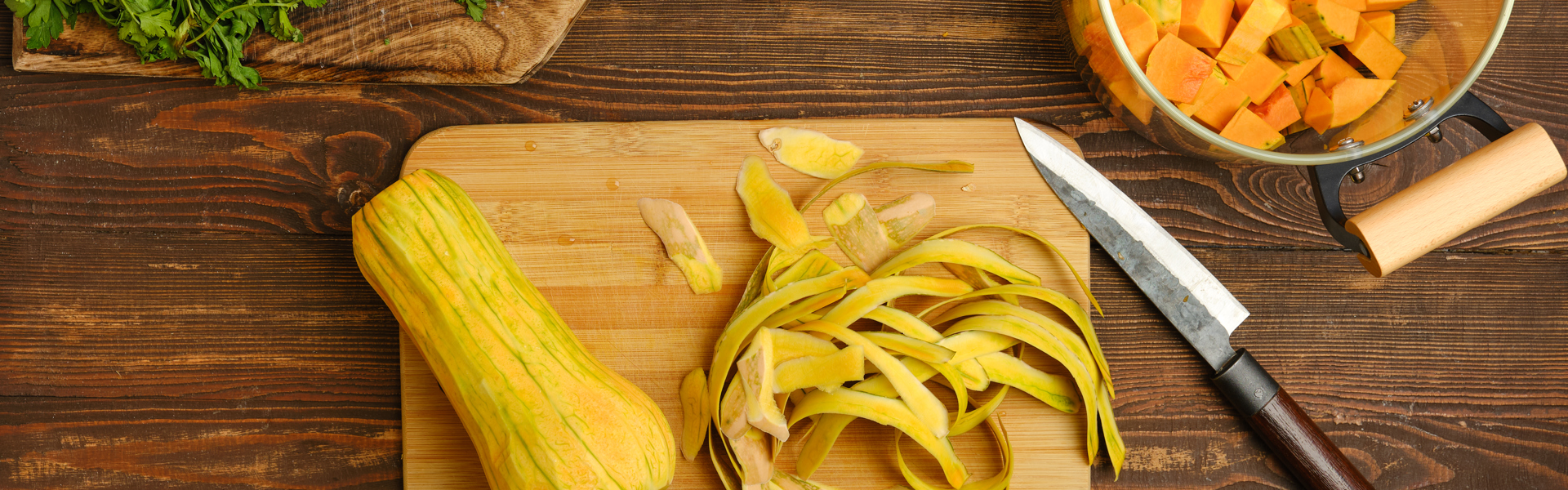 Main image: a butternut squash peeled and chopped along with other ingredients to make butternut squash curry.