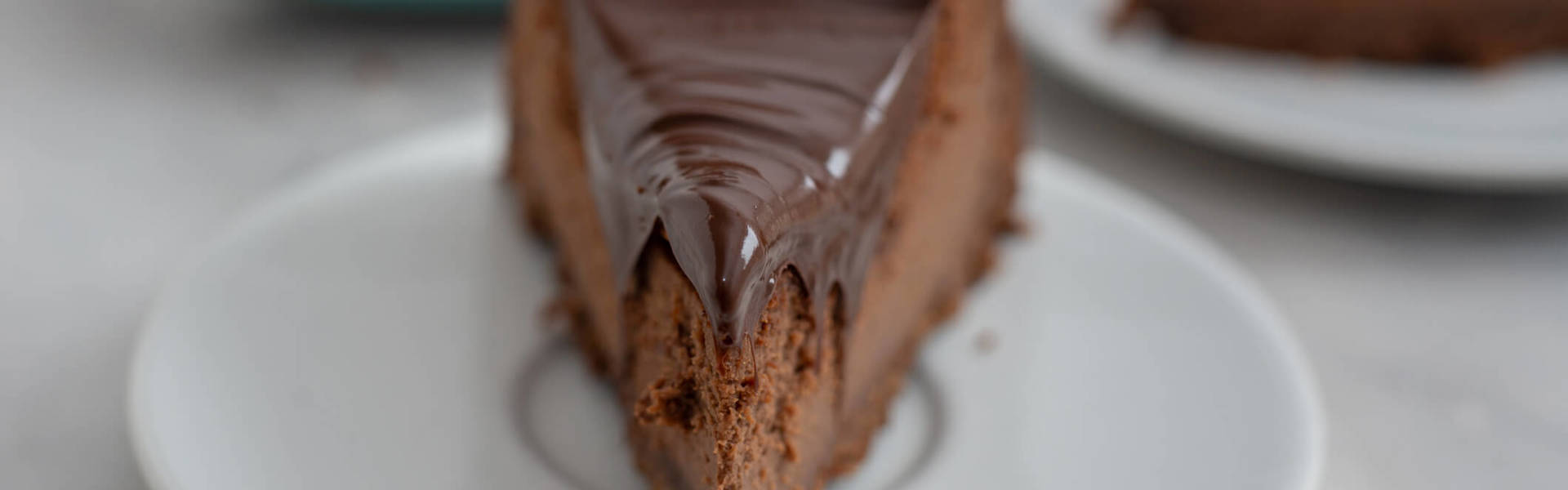 A slice of chocolate cheesecake on a white plate