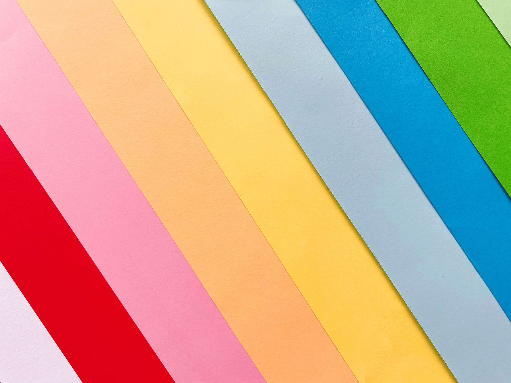 a rainbow of coloured card laid out in a fan