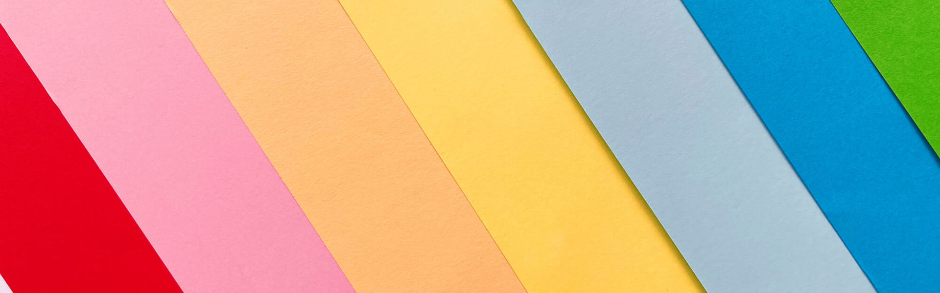 a rainbow of coloured card laid out in a fan