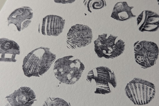 Main image: abstract art, made with playdoh stamps and ink - abstract stamp shapes in black ink on white paper.