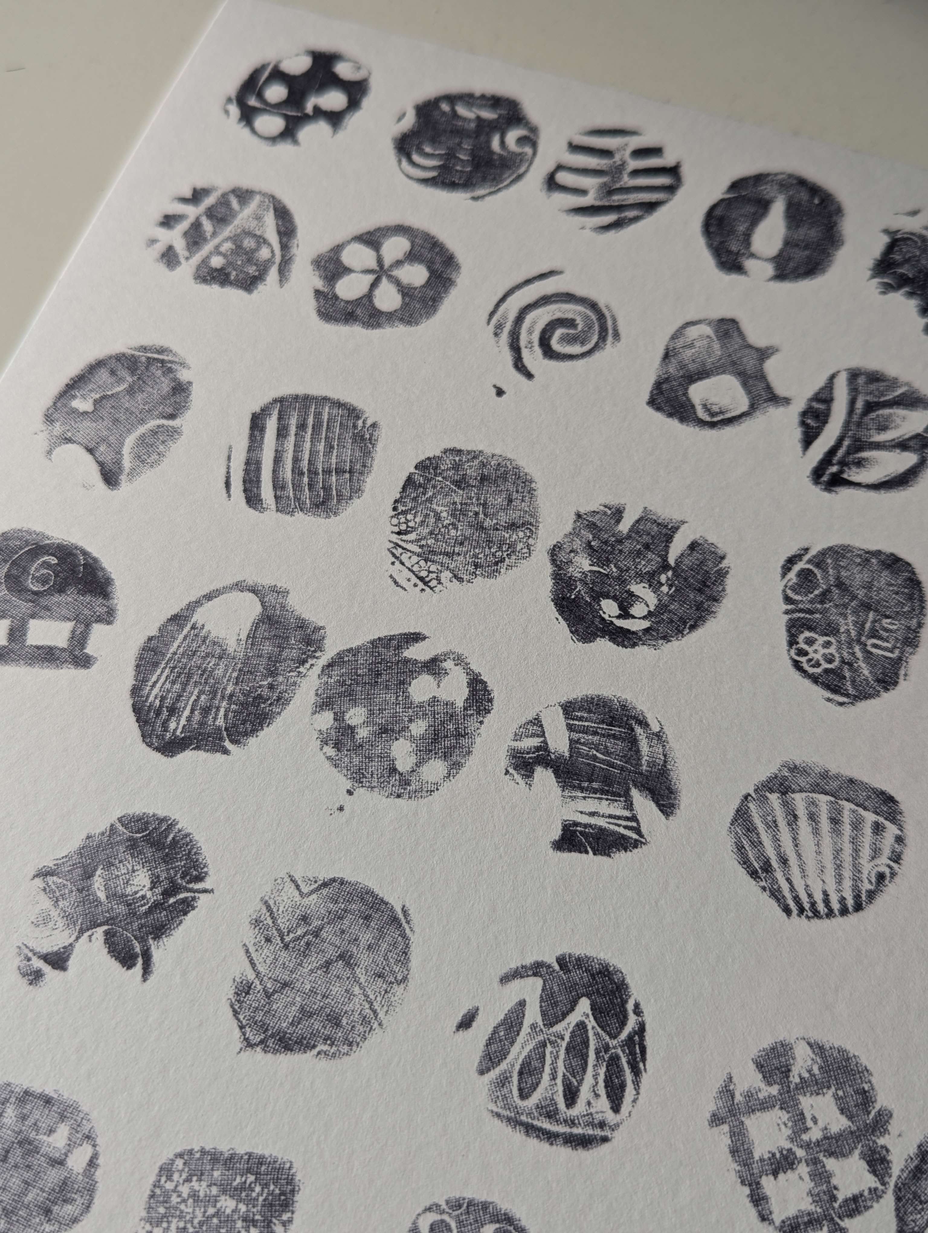 Main image: abstract art, made with playdoh stamps and ink - abstract stamp shapes in black ink on white paper.