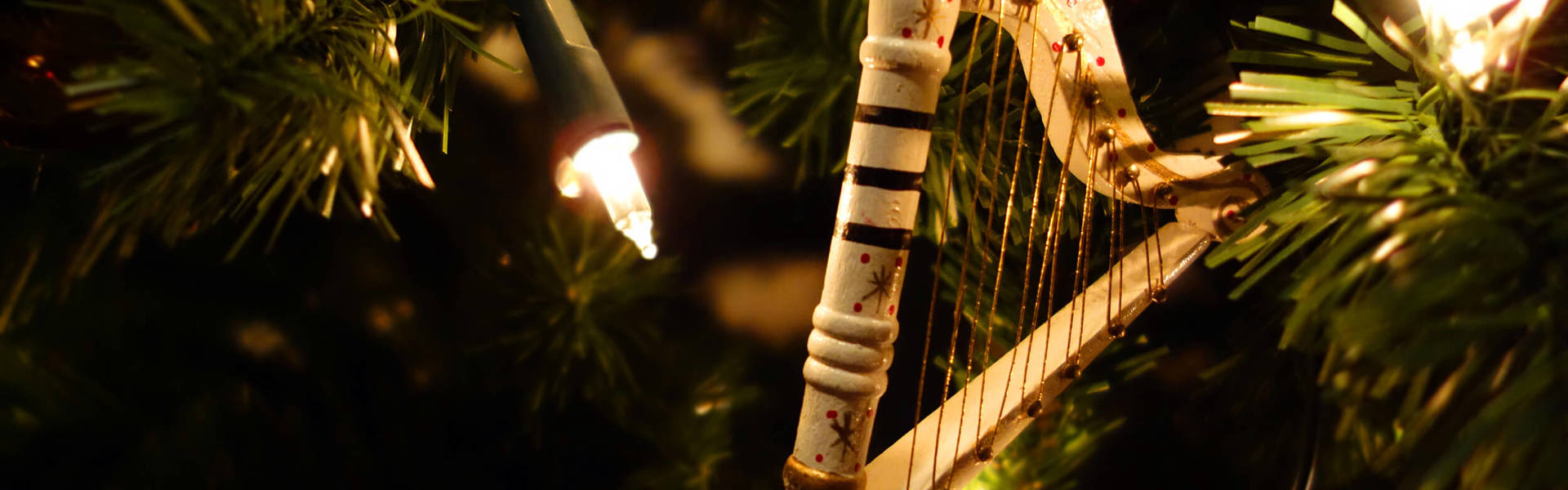 a small harp Christmas tree ornament in a Christmas tree