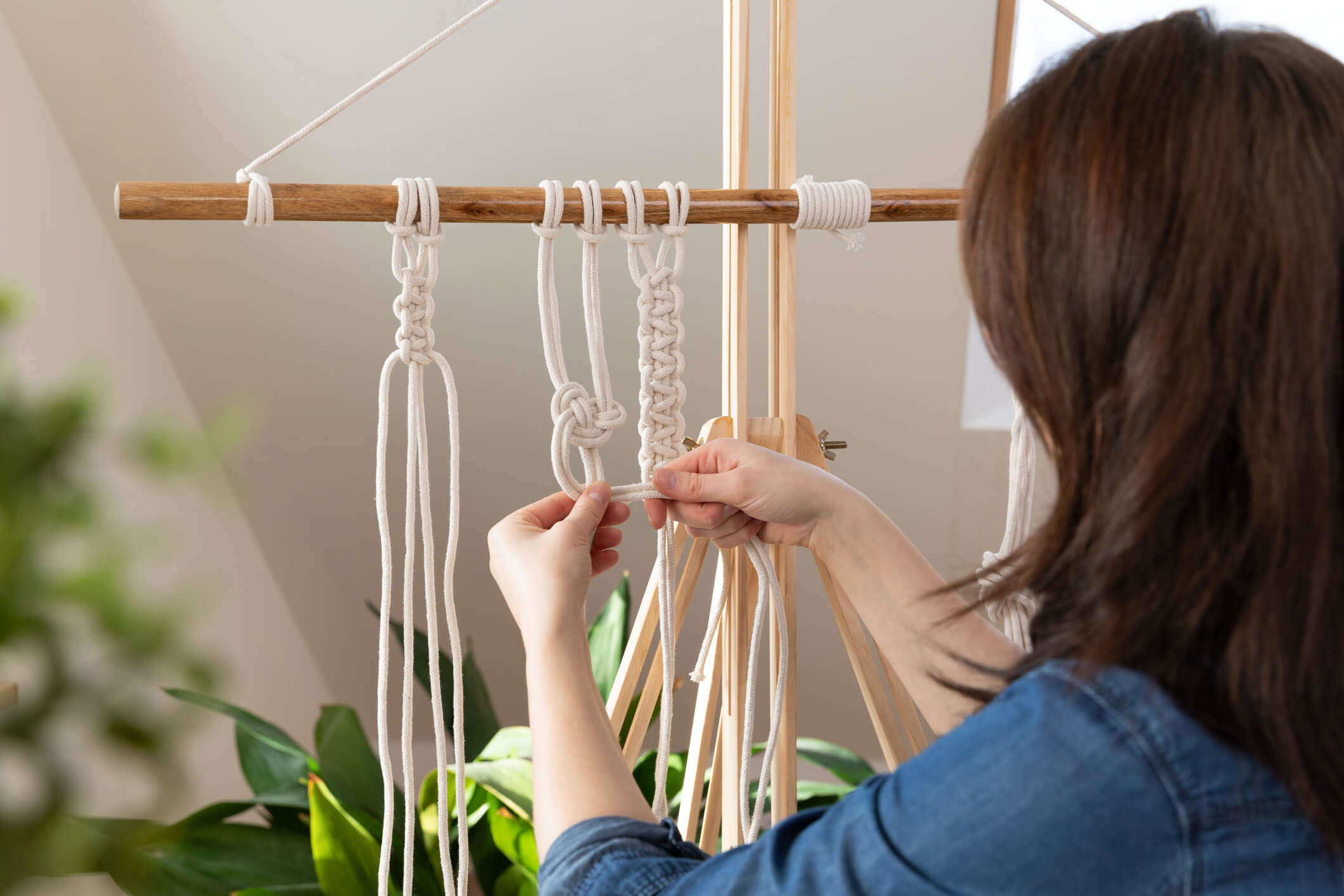 a woman creating a macramé work
