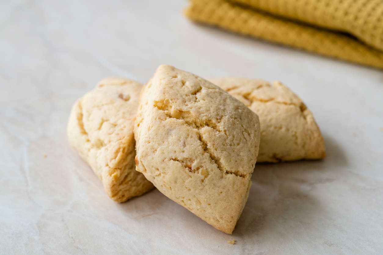 Three freshly baked shortbread biscuits on a white background