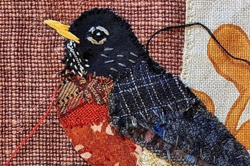 Main Image: A beautiful fabric collage bird, made using a variety of fabric scraps in blue and orange colours. Made using fabric collage techniques and slow stitching methods.