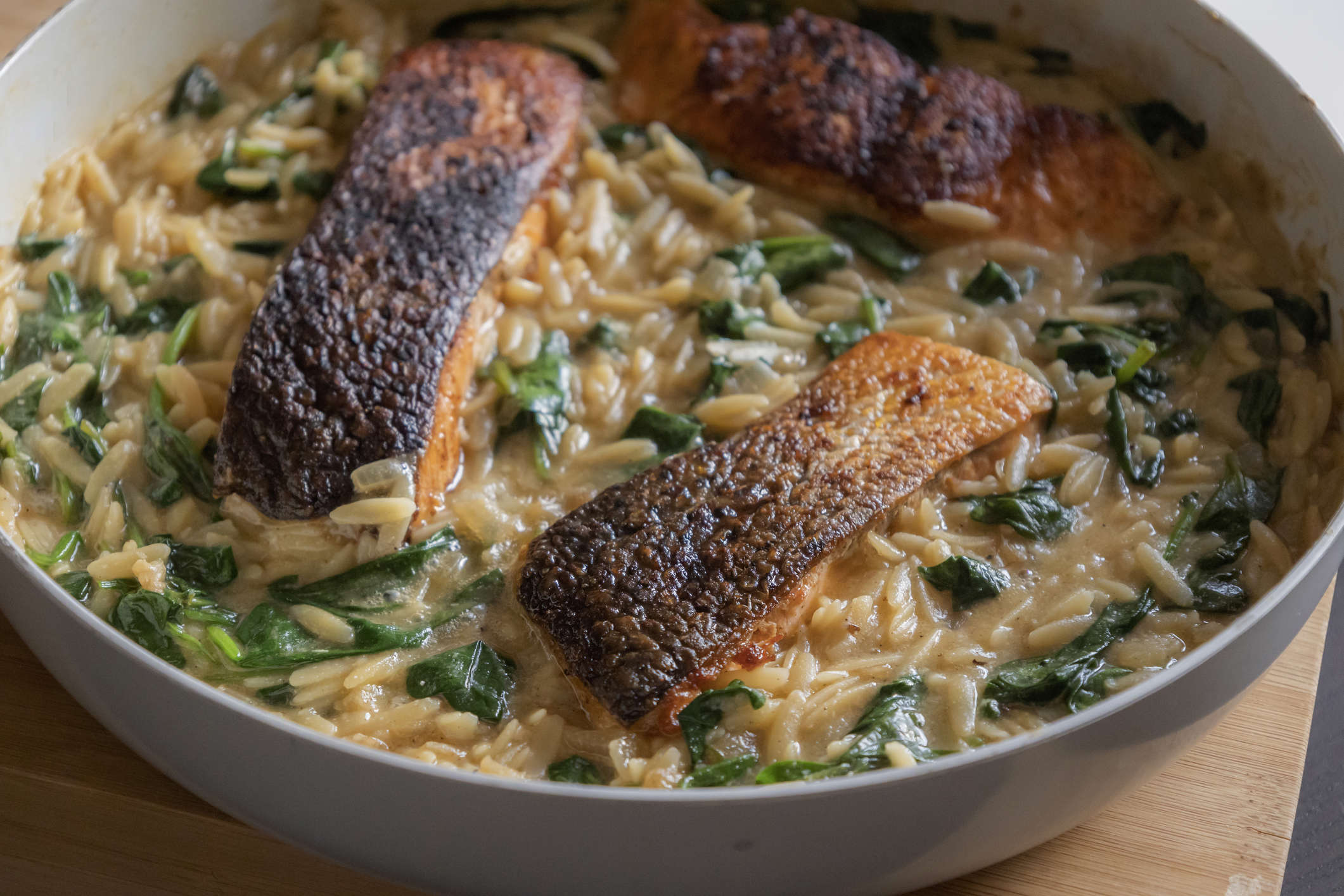 Main image: up close image of a summer salmon and orzo pesto salad in a grey bowl.