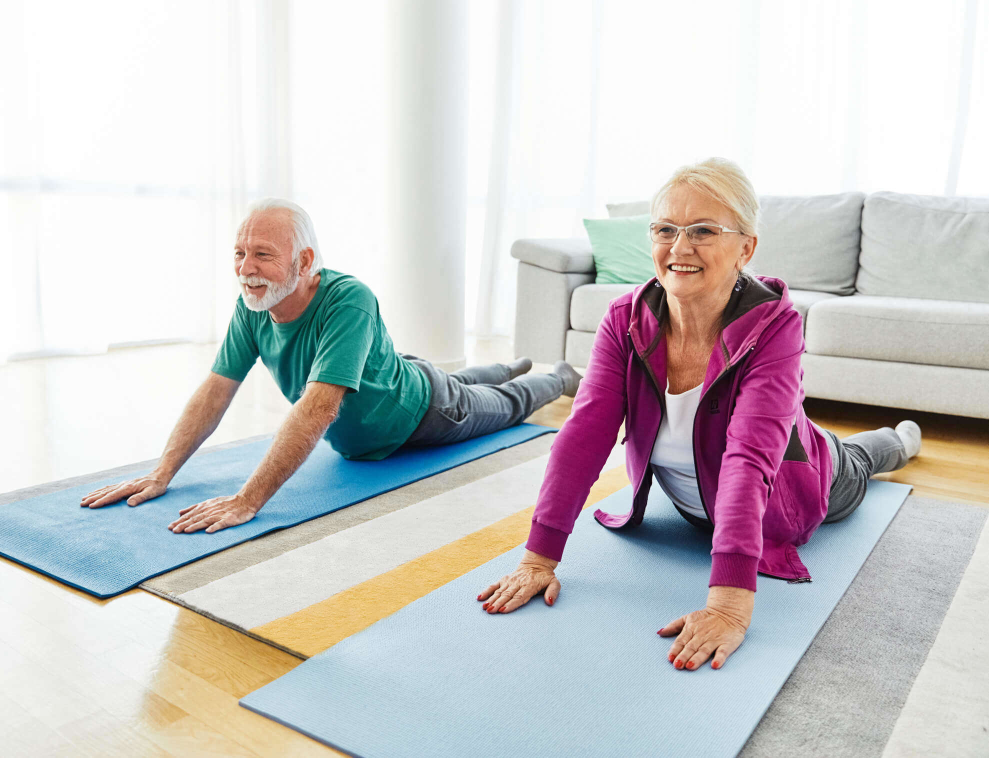 A couple doing yoga at home