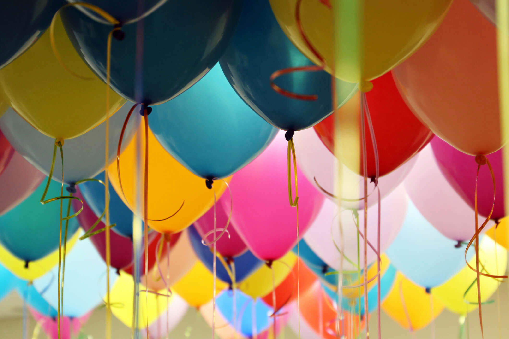 multicoloured birthday balloons floating in the air