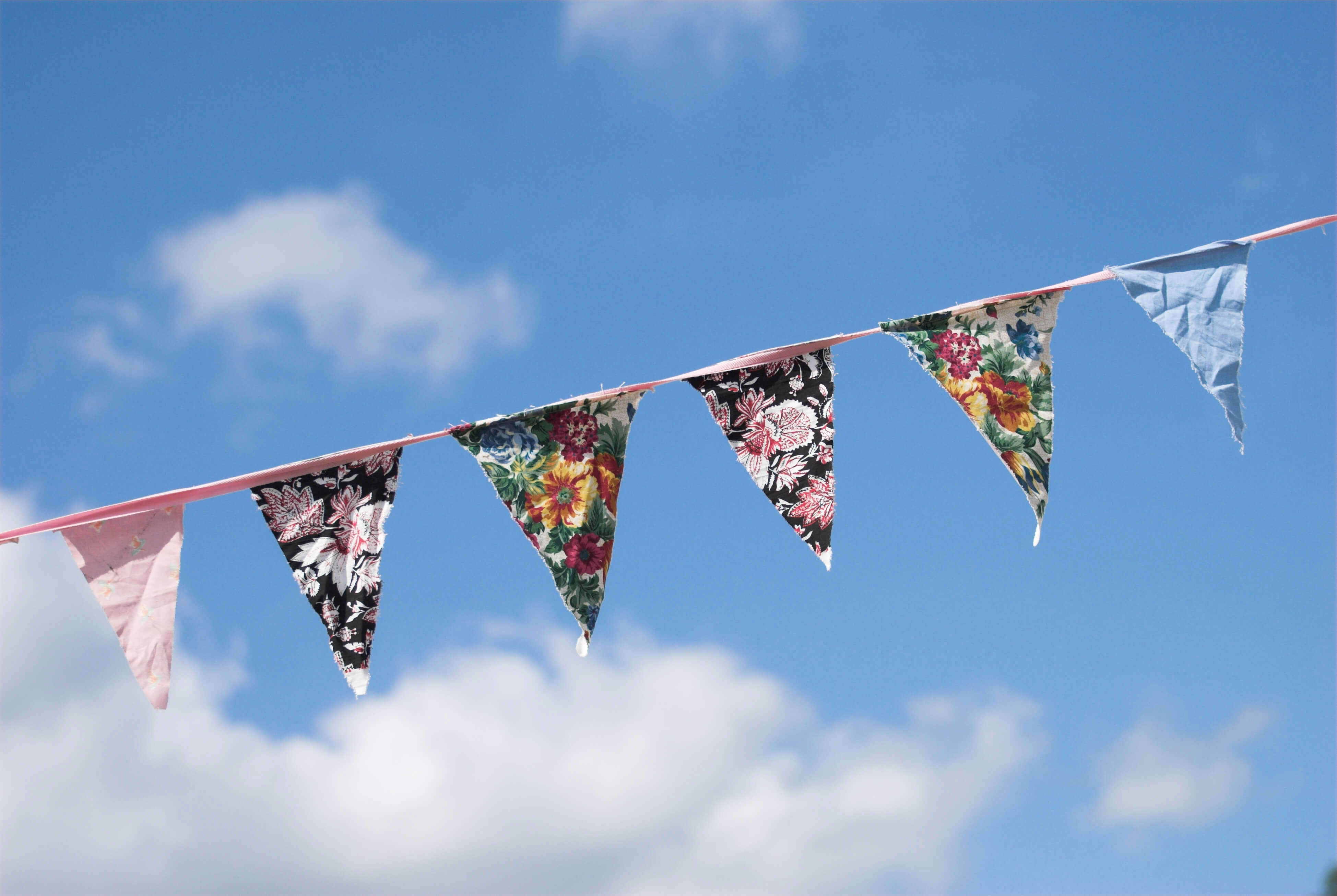 hand sewn vintage tea party bunting against a blue sky backdrop