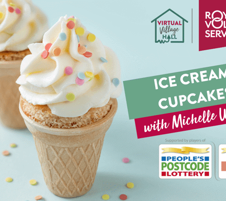 two ice cream cupcakes in ice cream cones with white icing and multicoloured sprinkles on a blue back ground