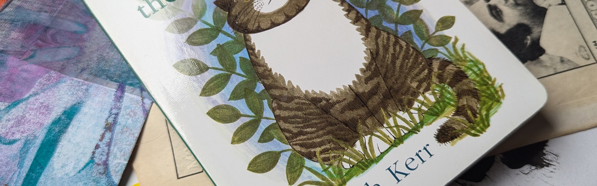 Main Image: A baby board book collage journal, the cover of the book is a grey tabby cat, with the title "Mog the Forgetful Cat, Judith Kerr"