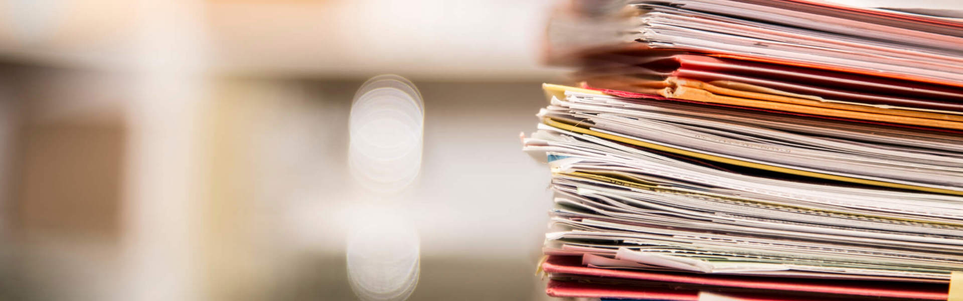 a close up of a stack of scrap paper on a work table