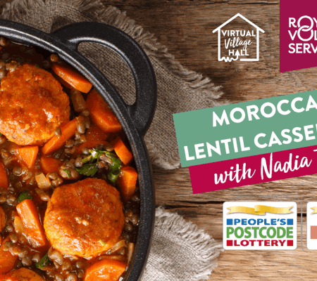 a homemade casserole in a black cooking pot on a wooden background