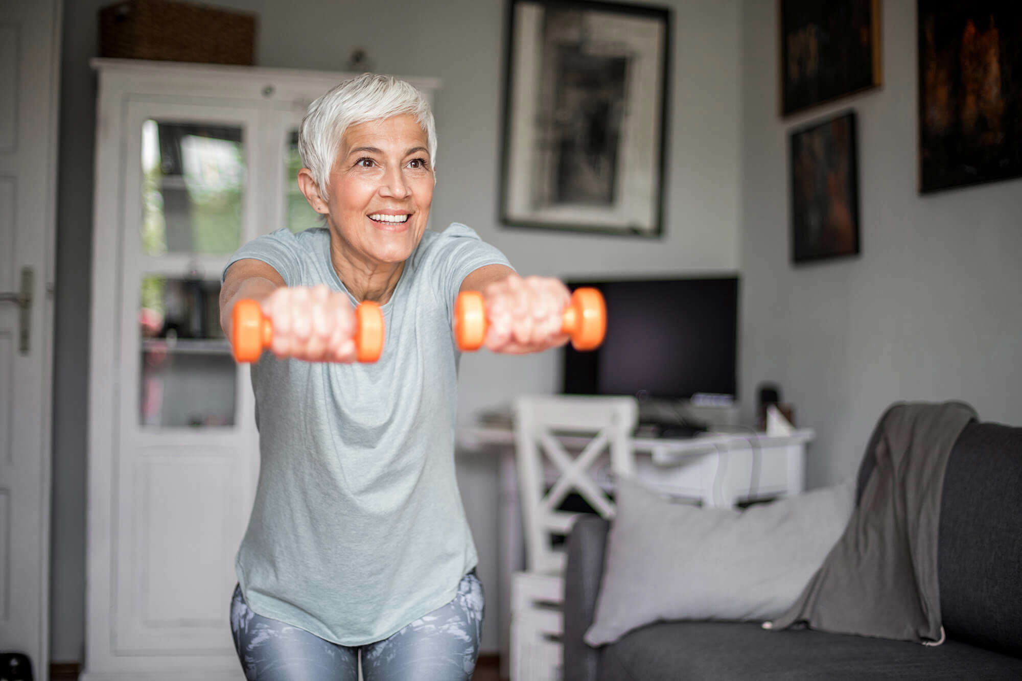 A woman working out with hand weights