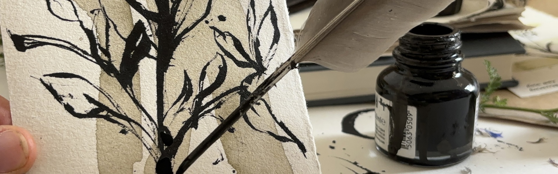 Feather Quill illustration a winter tree in black ink on white paper with ink bottle in the background